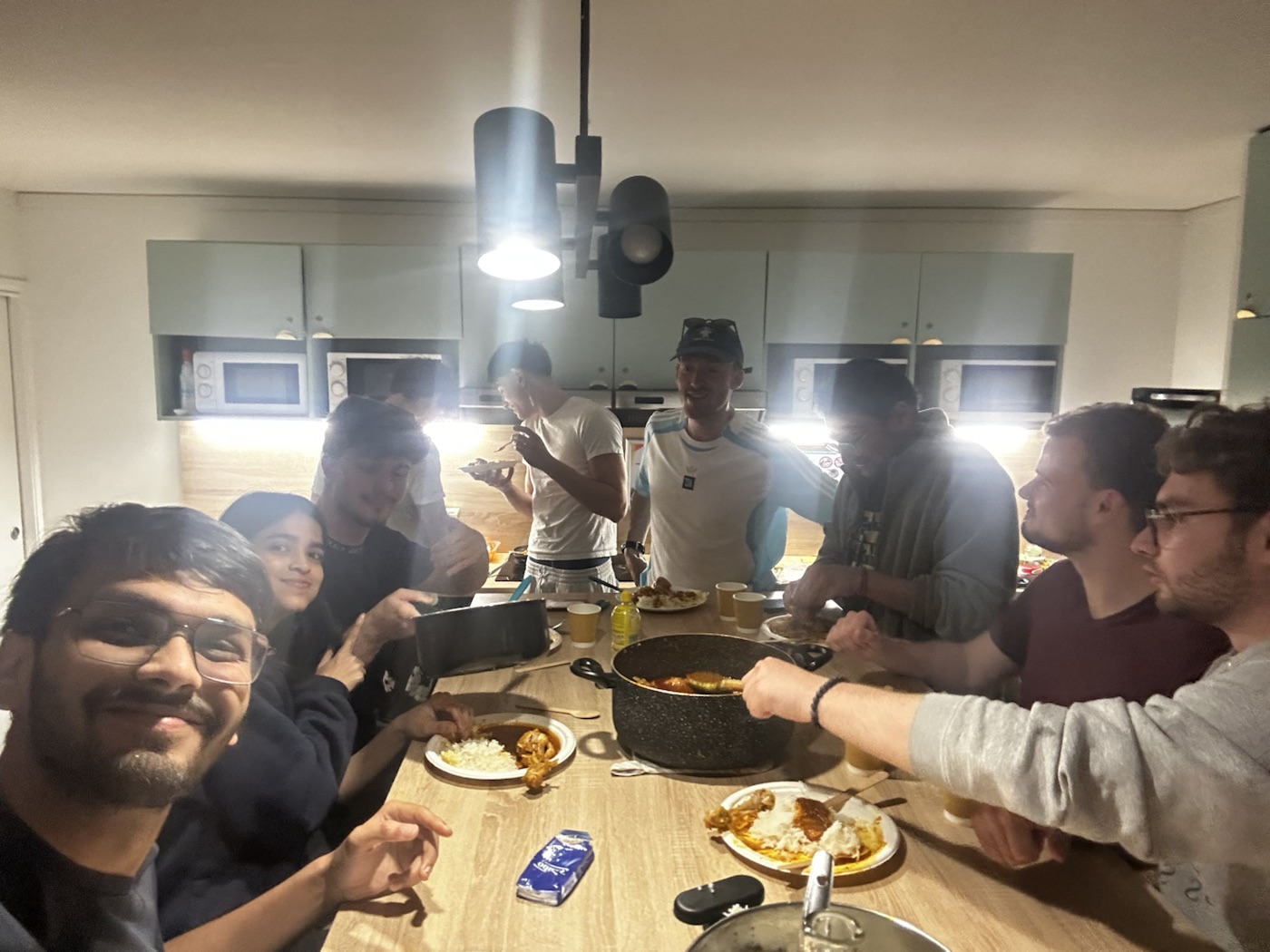 International friends sharing an Indian dinner around a table