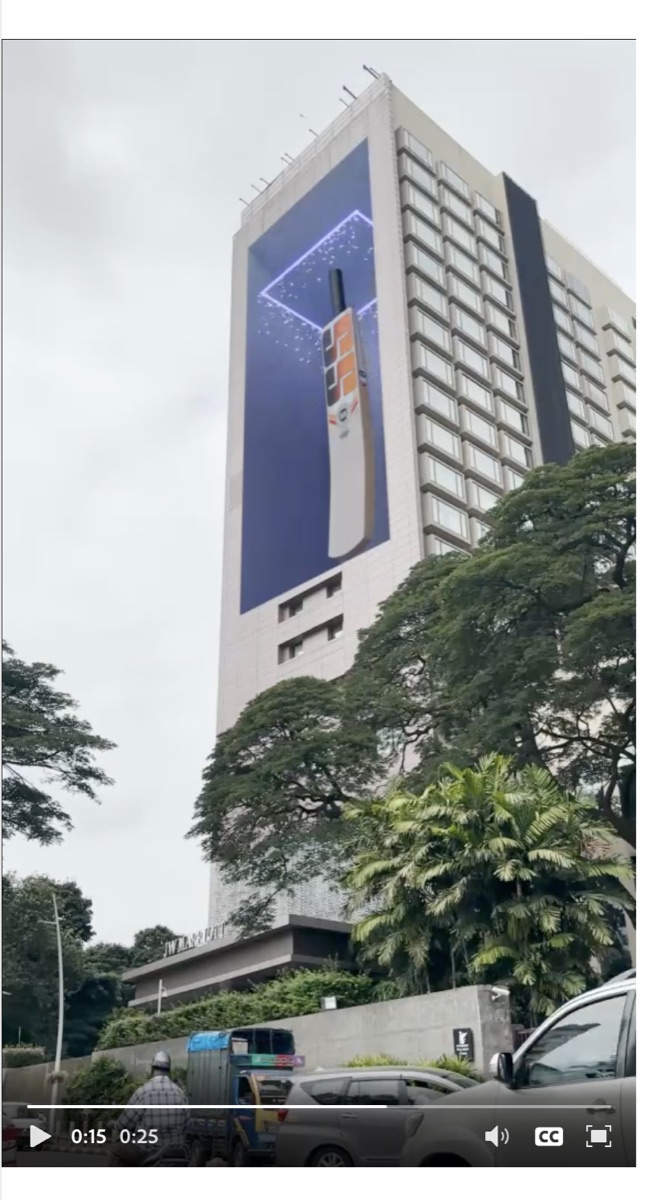 A large-scale digital installation displayed on a city building